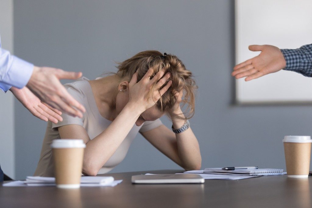 woman being shouted in the middle of the meeting