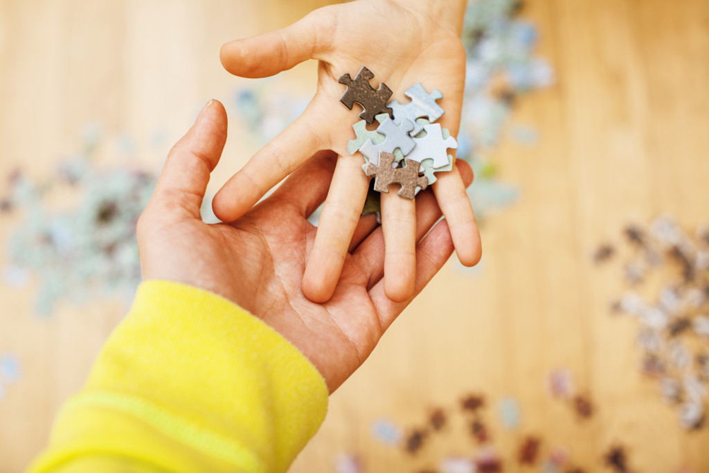 Kids' hands holding puzzle pieces