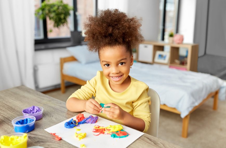 A child playing with colorful clay at home