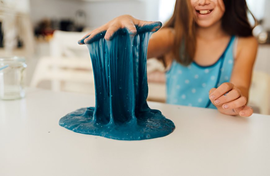 girl pulling blue slime up with her hand