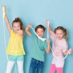three kids playing with fluffy slime